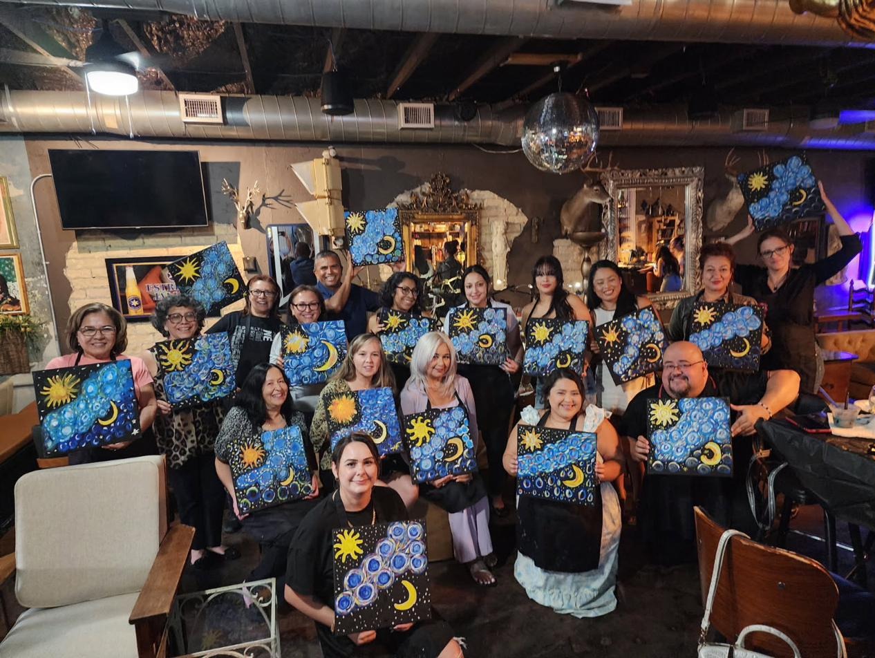 Guests holding sun and moon paintings